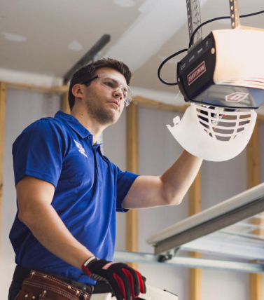 Technician Working on Garage Door Opener